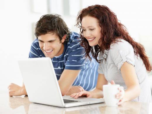 A couple using a 12" laptop.