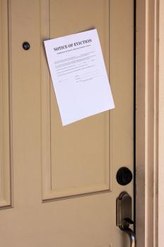 A notice of eviction posted on an apartment door.