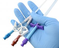 A healthcare professional holding rectal tubes.