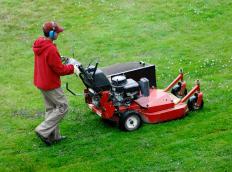 A man using a lawn mower.
