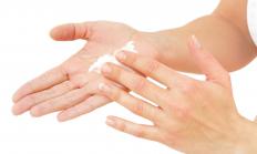 A woman using anti-aging hand cream.