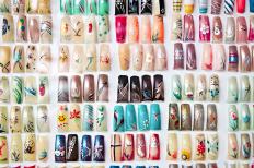 Assortment of artificial fingernails with airbrushed designs.