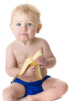 A self-weaning baby eating a banana