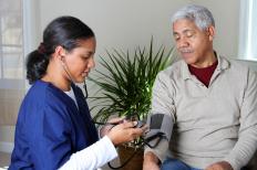 A medical professional checks a man's blood pressure. Nadolol may be prescribed to help lower blood pressure.