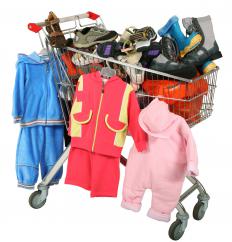 A shopping cart full of children's clothing, including some with zippers.