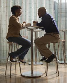 Couple having a cup of coffee on a singles cruise.