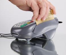 Credit card being swiped through a terminal