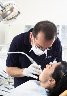 A dentist putting fillings in the teeth of a patient with Mountain Dew Mouth.