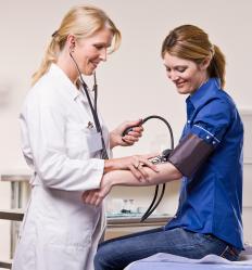 A doctor checking a patient's blood pressure.