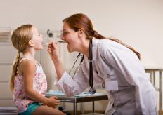 A doctor examining a child for laryngitis.