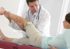 A healthcare provider examining a woman's calf.
