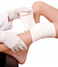 A medical professional wrapping a person
