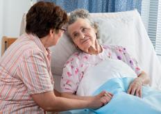 A woman assisting an elderly person.