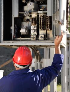 An electrical engineer inspecting a circuit breaker.