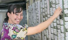 Employee pulling her punch card to clock in