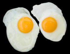 Eggs fried on a griddle.