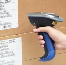 A cashier uses a handheld barcode scanner to check the price on an item.