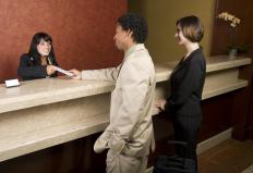 A hotel front desk manager checking in guests.