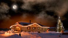 House with Christmas lights under the full moon