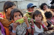 Impoverished children eating watermelon