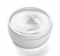 A jar of lotion containing lotus essential oil.