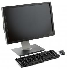A computer, keyboard, and mouse at a workstation.