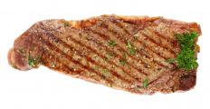A steak with garlic and parsley.
