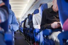 Some airline passengers carry a valise that can easily be stowed underneath their seat.