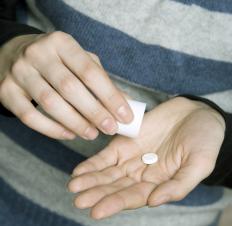 A person taking a water pill.
