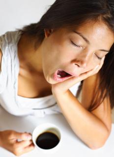 A woman yawning.