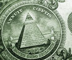 A detail of the eye on top of the pyramid on a US dollar.