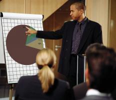 An event sales coordinator with a pie chart discussing figures with colleagues.