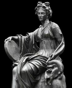 The Greek muse Thalia. She was the muse of comedy, and can be recognized by the comedic mask next to her.