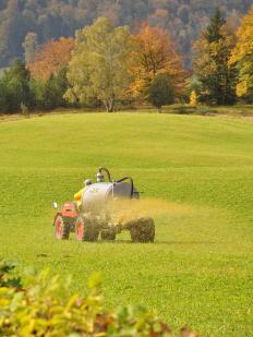 A farmer spreading urea fertilizer.
