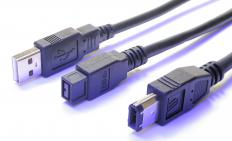 A USB cable to the left of two Firewire® cables.