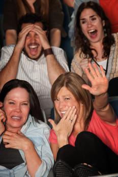 People watching a scary movie with a high rating.