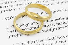 Wedding rings on top of a marriage contract.