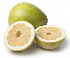 Whole pomelo along with a cut pomelo
