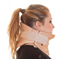 A woman wearing a neck brace for whiplash caused by a car accident.