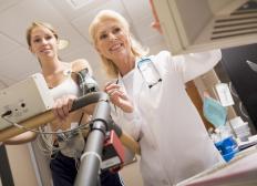 Woman on a treadmill reviewing results with her doctor