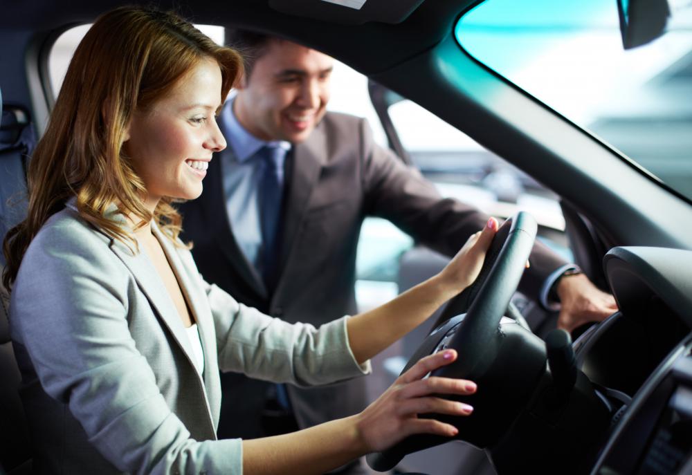 Salesman showing car interior to woman