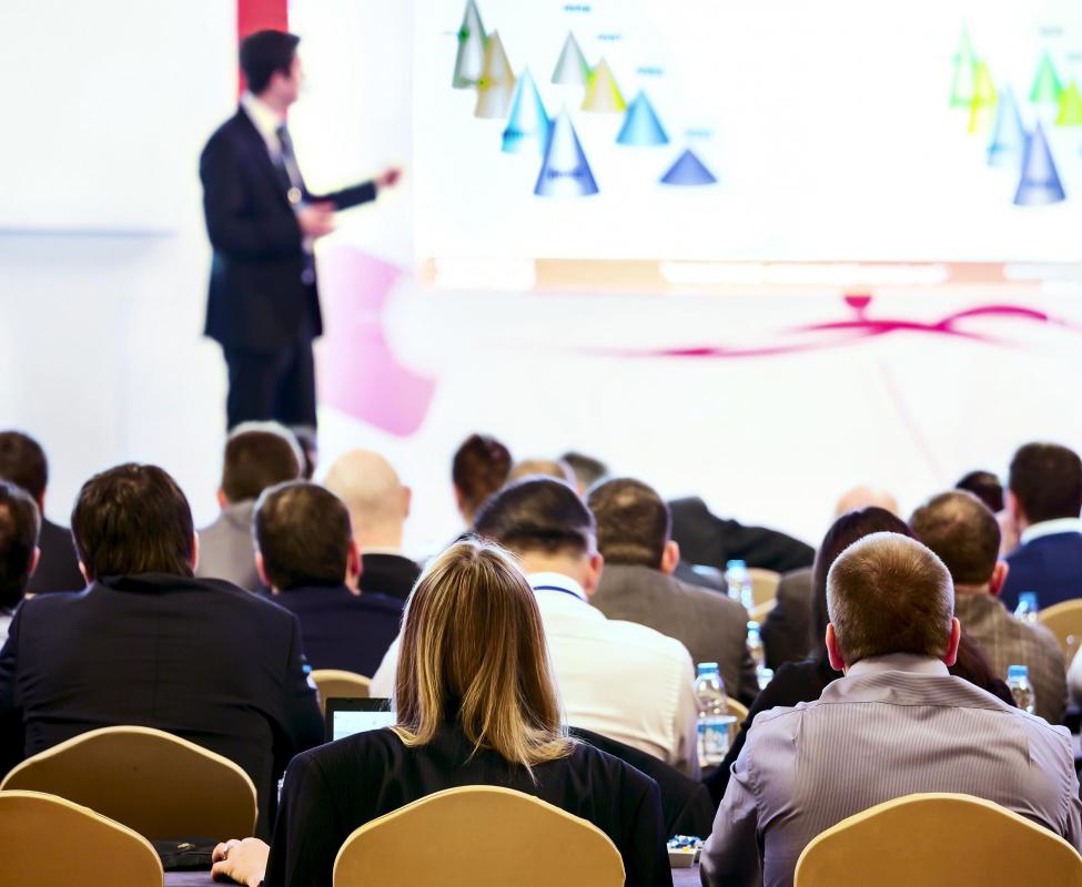  Attendee taking notes at a personal development seminar