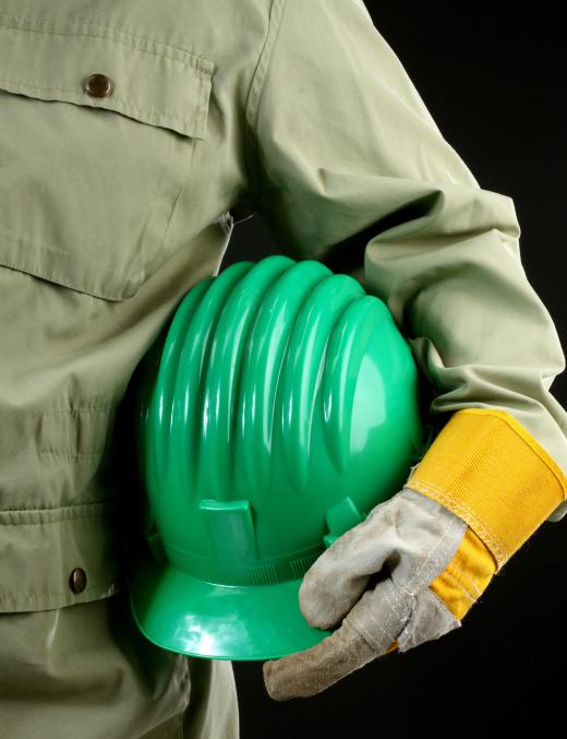 A metal machinist must wear safety equipment such as hard hats.