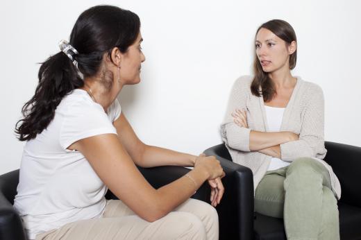 A somatic psychologist uses body language, such as arms crossed over the chest, to help identify a patient's mental state and wellness.