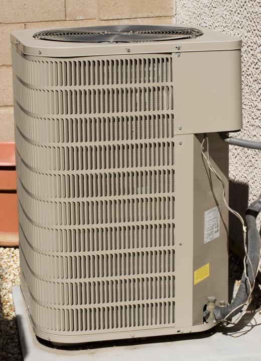 An HVAC mechanic repairs air conditioning units.