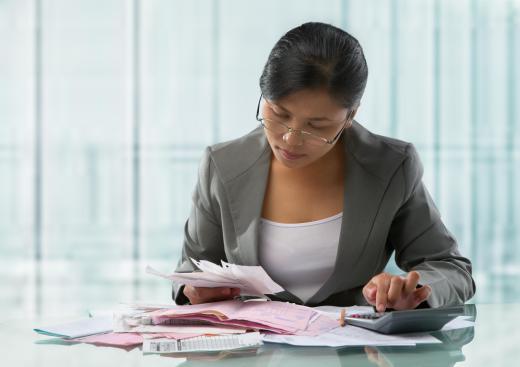 An auditor going over business receipts.