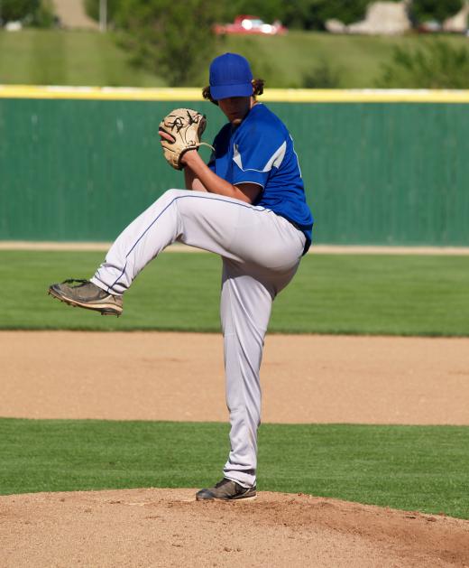 A pitcher wearing a baseball cap.