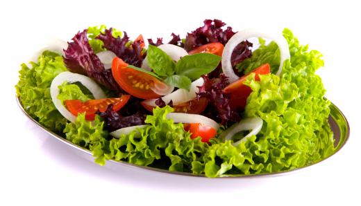 A salad garnished with basil.