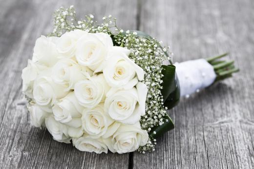 A wedding planner can help a bride choose a bouquet.