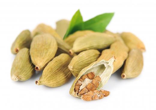 Cardamom seed pods, with one opened.